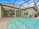 Relax by the pool, steps from the covered patio and home's interior at 143 Brunswick Dr, Davenport, FL 33837