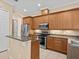 Kitchen with wood cabinets, stainless steel appliances at 143 Brunswick Dr, Davenport, FL 33837