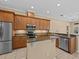 Kitchen boasts stainless steel appliances and wood cabinets at 143 Brunswick Dr, Davenport, FL 33837