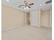 Large bedroom with carpeted floor, ceiling fan and access to hallway at 143 Brunswick Dr, Davenport, FL 33837