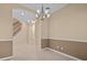 Two-toned dining room with a chandelier and staircase view at 143 Brunswick Dr, Davenport, FL 33837