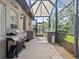 Outdoor kitchen with grill and screened enclosure at 143 Brunswick Dr, Davenport, FL 33837