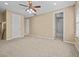 Spacious bedroom with carpet, ceiling fan and access to bathroom at 143 Brunswick Dr, Davenport, FL 33837