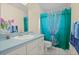 Clean bathroom with teal shower curtain, single vanity, and toilet at 2101 Appy Ln, Apopka, FL 32712