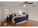 Spacious bedroom with wood flooring, large bed, and plenty of natural light at 2101 Appy Ln, Apopka, FL 32712