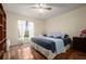 Bedroom with king-size bed, hardwood floors, and ample natural light at 2101 Appy Ln, Apopka, FL 32712