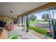 Covered patio overlooks a spacious backyard with a large above ground pool at 2101 Appy Ln, Apopka, FL 32712