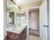 Bathroom with double vanity and brown cabinets at 13950 Morning Frost Dr, Orlando, FL 32828