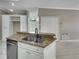 Kitchen island with granite countertop and stainless steel sink at 526 Pinehurst Cv, Kissimmee, FL 34758