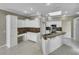 White kitchen with granite countertops and an island at 526 Pinehurst Cv, Kissimmee, FL 34758