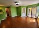 Bright living room featuring wood laminate flooring and access to a patio at 3012 S Semoran Blvd # 3, Orlando, FL 32822