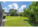 Landscaped backyard with lush greenery and a stone path at 13272 Roxboro Rd, Windermere, FL 34786