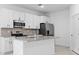 Modern kitchen with white cabinets, granite island and stainless steel appliances at 2866 Lingo Ln, Orlando, FL 32822