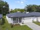 New single story house, gray exterior, two car garage, and landscaped yard at 2866 Lingo Ln, Orlando, FL 32822