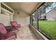 Relaxing screened porch with wicker furniture and backyard view at 1473 Farrindon Cir, Lake Mary, FL 32746