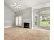 Bright living room with vaulted ceilings, fireplace and large windows at 1473 Farrindon Cir, Lake Mary, FL 32746