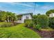 Side view of a ranch-style home with well-maintained landscaping at 400 W Trotters Dr, Maitland, FL 32751