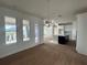 Dining area with modern light fixture, large windows, and view of the kitchen at 9982 Fiddley Aly, Orlando, FL 32827