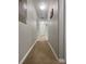 Long hallway with carpeted floors connecting to other rooms at 8943 Bismarck Palm Rd, Kissimmee, FL 34747