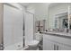 Well-appointed bathroom with a walk-in shower, toilet, and white cabinetry at 2422 Greenwood Oak Dr, Ocoee, FL 34761