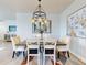 Elegant dining room with a rustic table and statement chandelier at 5 Riverwalk Dr # 407, New Smyrna Beach, FL 32169