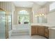 Large bathroom with a soaking tub, double vanity, and updated fixtures at 6659 Crenshaw Dr, Orlando, FL 32835