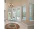 Elegant dining room with a glass-top table and chandelier at 6659 Crenshaw Dr, Orlando, FL 32835