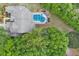 Aerial view showing home, pool, and lush green surroundings at 6659 Crenshaw Dr, Orlando, FL 32835