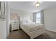 Bedroom with a queen bed, white bedding and dresser at 1427 Rolling Fairway Dr, Davenport, FL 33896