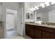Double vanity bathroom with granite countertops and a large mirror at 1427 Rolling Fairway Dr, Davenport, FL 33896