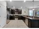 Modern kitchen with dark cabinets and stainless steel appliances at 1427 Rolling Fairway Dr, Davenport, FL 33896