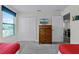 Bedroom with twin beds, dresser, and access to another room at 1427 Rolling Fairway Dr, Davenport, FL 33896