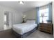 Cozy bedroom with a full-size bed and wooden dresser at 1427 Rolling Fairway Dr, Davenport, FL 33896