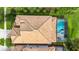 Bird's eye view of house, highlighting the roof and pool area at 1427 Rolling Fairway Dr, Davenport, FL 33896