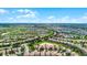 Aerial view of a community with houses, landscaping, and a golf course at 1427 Rolling Fairway Dr, Davenport, FL 33896