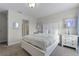 Bright bedroom with a white bed frame and built-in dresser at 1427 Rolling Fairway Dr, Davenport, FL 33896