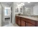 Bathroom with double vanity, granite countertop and access to bedroom at 1427 Rolling Fairway Dr, Davenport, FL 33896