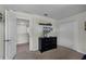 Bedroom with a dresser, TV, and access to a hallway at 1427 Rolling Fairway Dr, Davenport, FL 33896