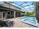 Inviting pool and spa with screened patio and lounge chairs at 1427 Rolling Fairway Dr, Davenport, FL 33896