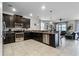 Open concept kitchen with dark cabinets and stainless steel appliances at 1427 Rolling Fairway Dr, Davenport, FL 33896
