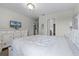 Main bedroom with a queen bed, white bedding, and dresser at 1427 Rolling Fairway Dr, Davenport, FL 33896