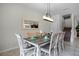 Formal dining room with a rustic table and six chairs at 1427 Rolling Fairway Dr, Davenport, FL 33896