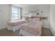 Charming bedroom featuring two twin beds with pink bedding at 1427 Rolling Fairway Dr, Davenport, FL 33896