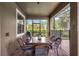 Covered patio with wicker dining set, perfect for outdoor meals at 1427 Rolling Fairway Dr, Davenport, FL 33896