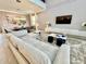Open living area with sectional sofa and views into dining area at 9095 Sommerset Hills Dr, Davenport, FL 33896