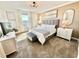 Main bedroom with a king bed, neutral color palette, and large window at 9095 Sommerset Hills Dr, Davenport, FL 33896