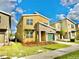 Two-story modern home with stone accents and a green garage door at 9095 Sommerset Hills Dr, Davenport, FL 33896