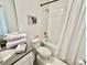 Clean bathroom with a tub shower combo, white vanity, and grey flooring at 9095 Sommerset Hills Dr, Davenport, FL 33896