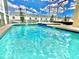 Enclosed pool and spa with lounge chairs for relaxation at 9095 Sommerset Hills Dr, Davenport, FL 33896