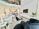 Open concept living area with sectional sofa and high ceilings at 9095 Sommerset Hills Dr, Davenport, FL 33896